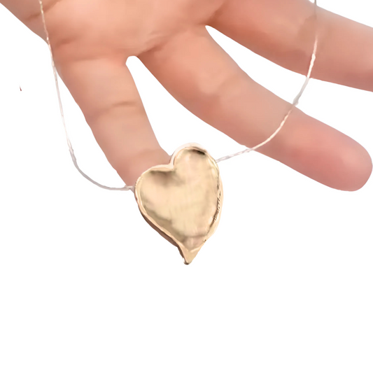 Elegant heart pendant in 9k yellow gold with a polished finish, hanging from a delicate silver chain. This charming pendant is a perfect gift for her, ideal for Christmas, Valentine’s Day, or any special occasion, expressing love and sophistication