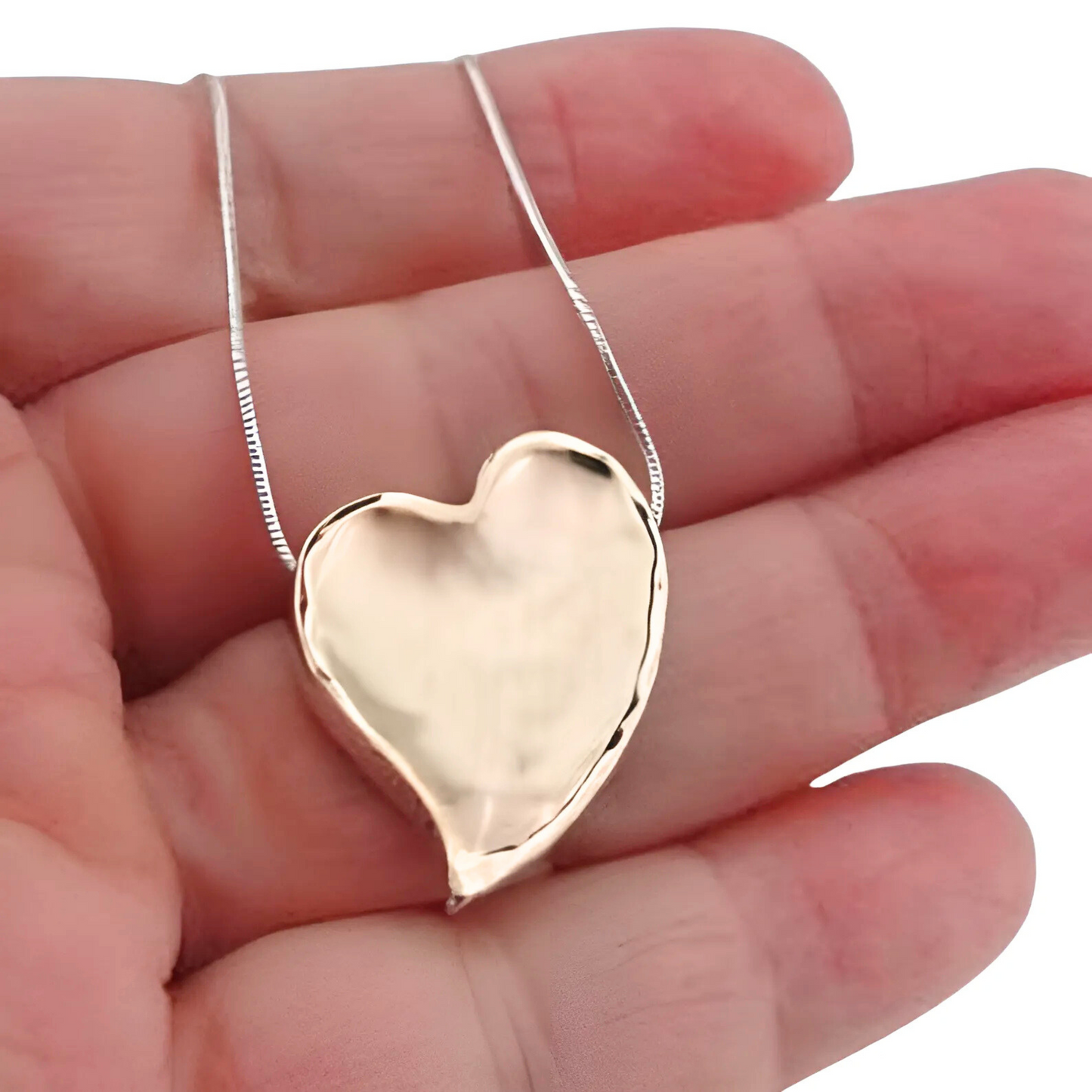 Elegant heart pendant in 9k yellow gold with a polished finish, hanging from a delicate silver chain. This charming pendant is a perfect gift for her, ideal for Christmas, Valentineās Day, or any special occasion, expressing love and sophistication