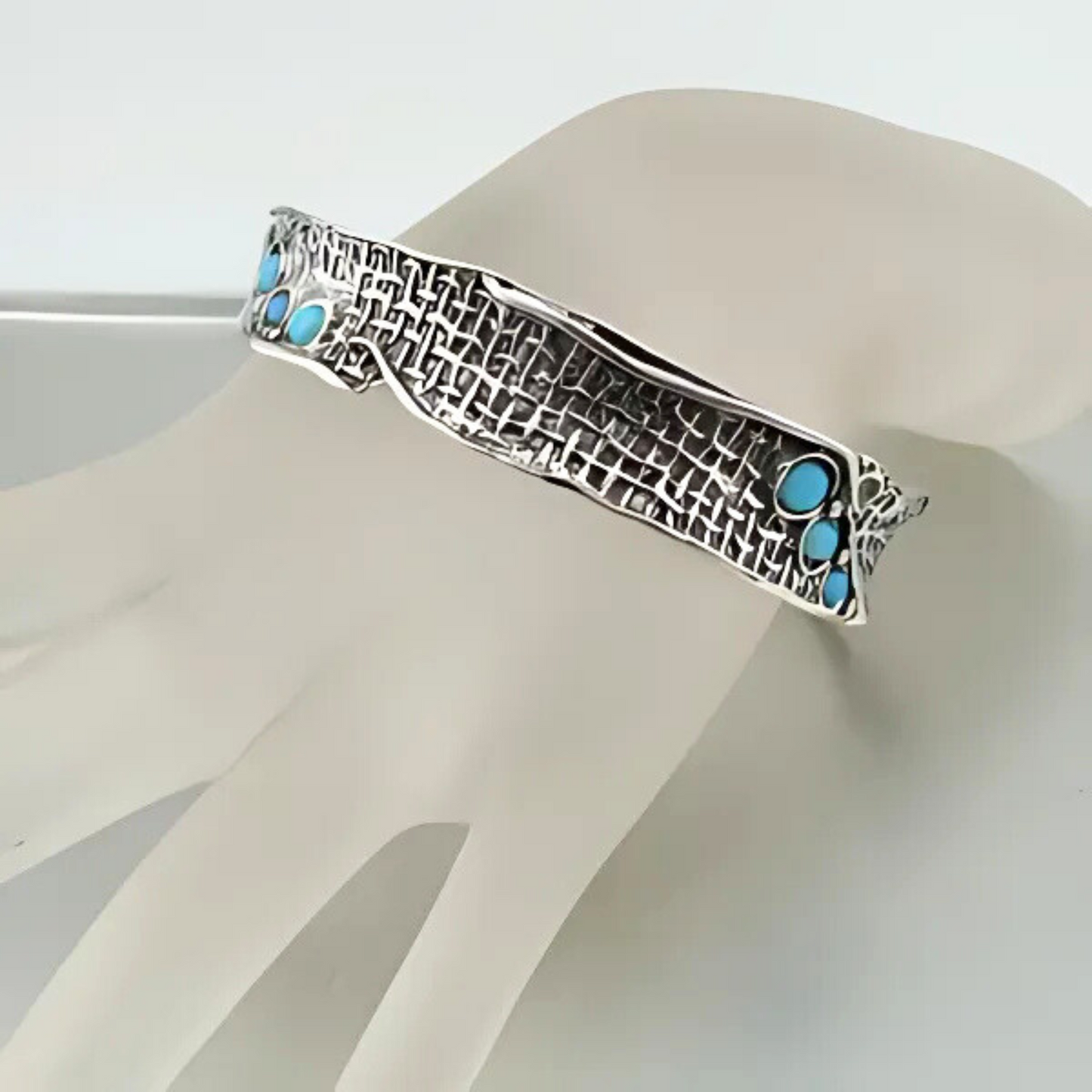 Darkened sterling silver bracelet with an intricate textured net pattern, accented with eight vibrant blue mosaic opal gemstones. From the 'Nets' collection, this artistic, wide-band bracelet offers a bold and unique statement piece for lovers of luxury silver jewelry and distinctive gemstone designs
