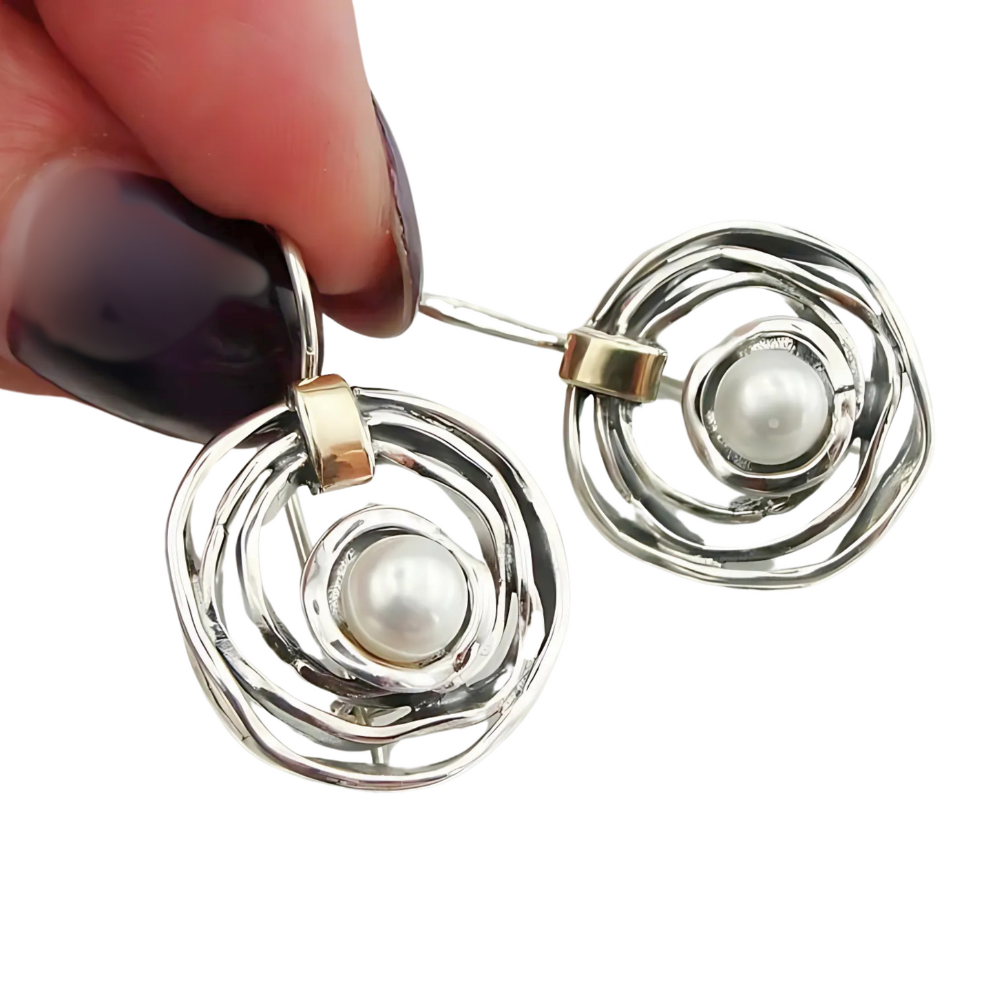 Elegant, handcrafted sterling silver earrings with a sophisticated open spiral design, featuring lustrous freshwater pearls as centerpieces and accented with delicate touches of yellow gold. These unique earrings, designed by Hadar Jewelry, blend modern aesthetics with timeless luxury, perfect for adding a refined, statement look to any ensemble.