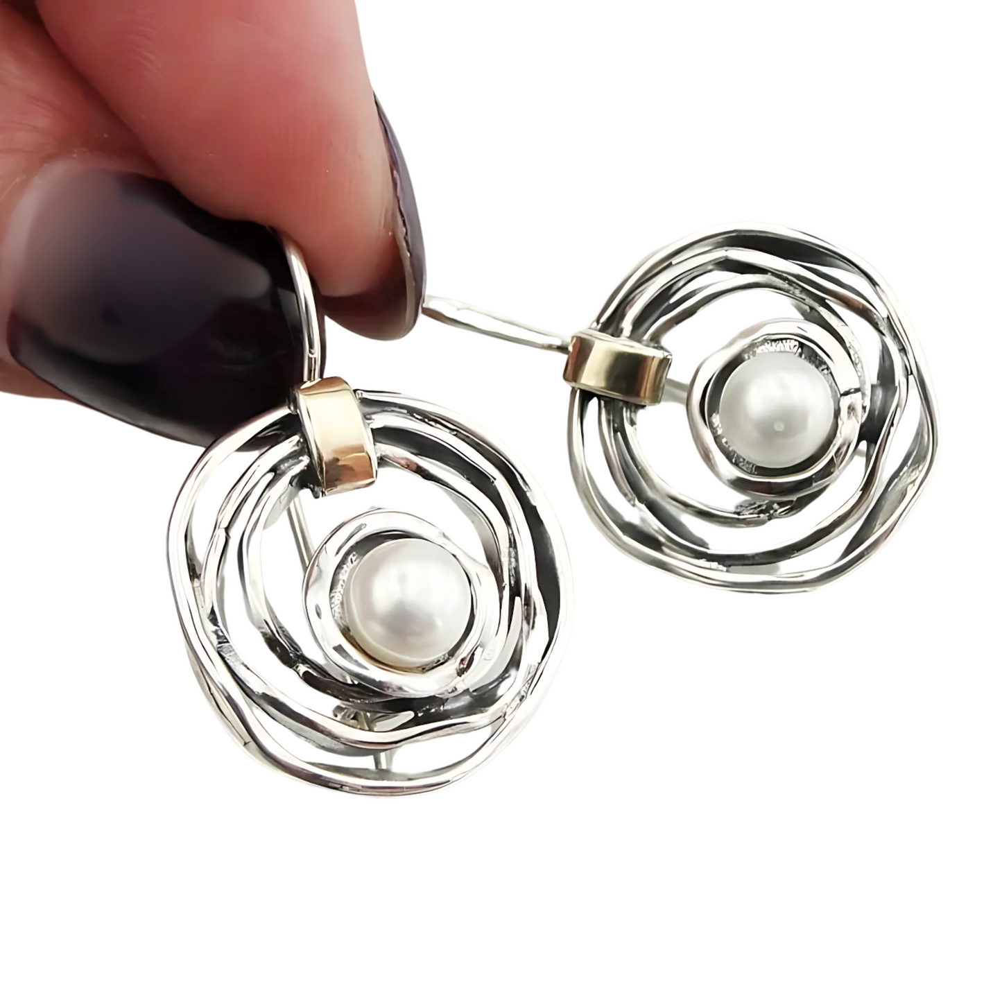 Elegant, handcrafted sterling silver earrings with a sophisticated open spiral design, featuring lustrous freshwater pearls as centerpieces and accented with delicate touches of yellow gold. These unique earrings, designed by Hadar Jewelry, blend modern aesthetics with timeless luxury, perfect for adding a refined, statement look to any ensemble.