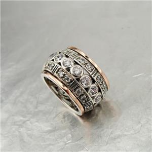 Sterling silver ring with 9k rose gold decorated with sparkling zircons.