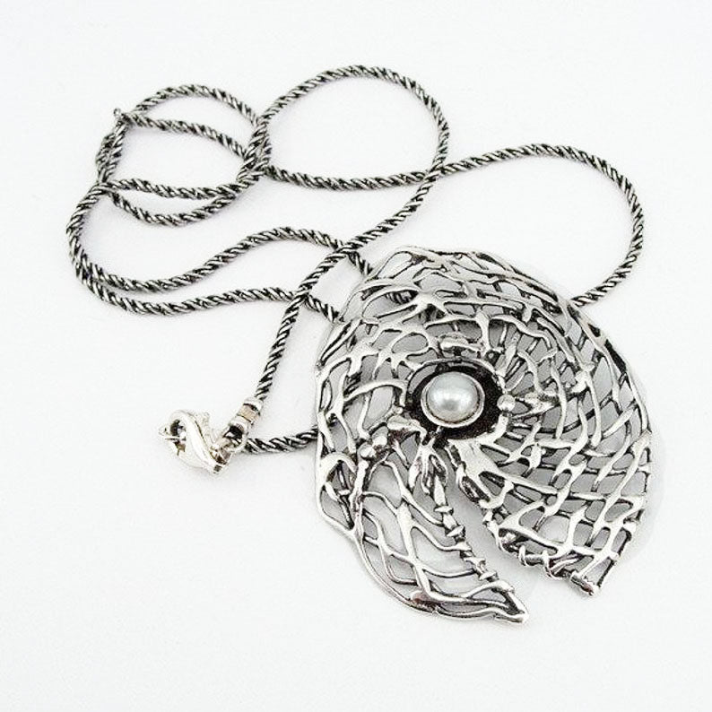 Round sterling silver net pendant with white natural gemstone.