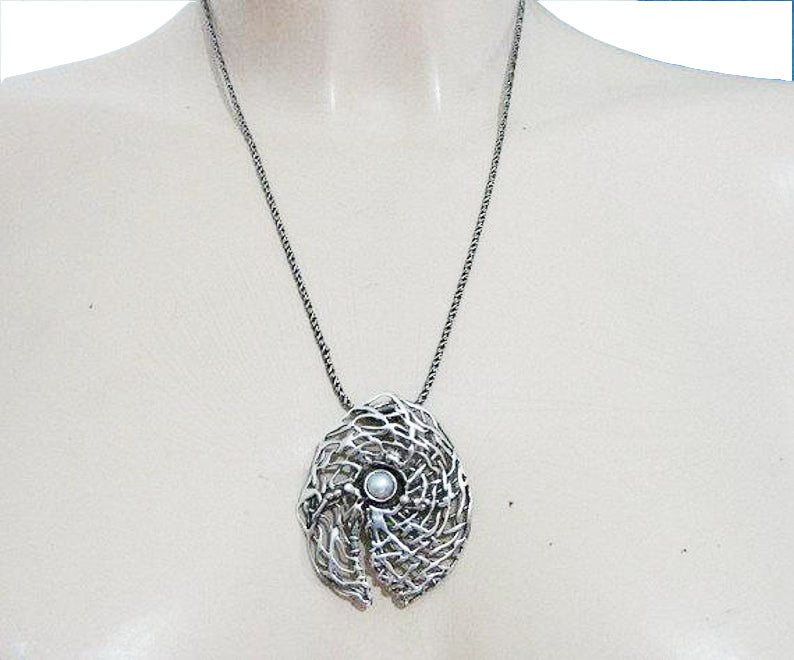 Round sterling silver net pendant with white natural gemstone.