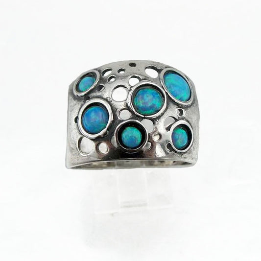Sterling silver wide ring with blue opal dots.