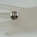 Wide and Swivelling Sterling silver ring, decorated with red gold swivel bands