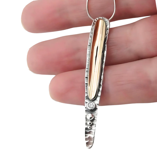 Sterling silver and 9K yellow gold pendant with a clear zircon, modern and elegant design, perfect for a meaningful Christmas gift.