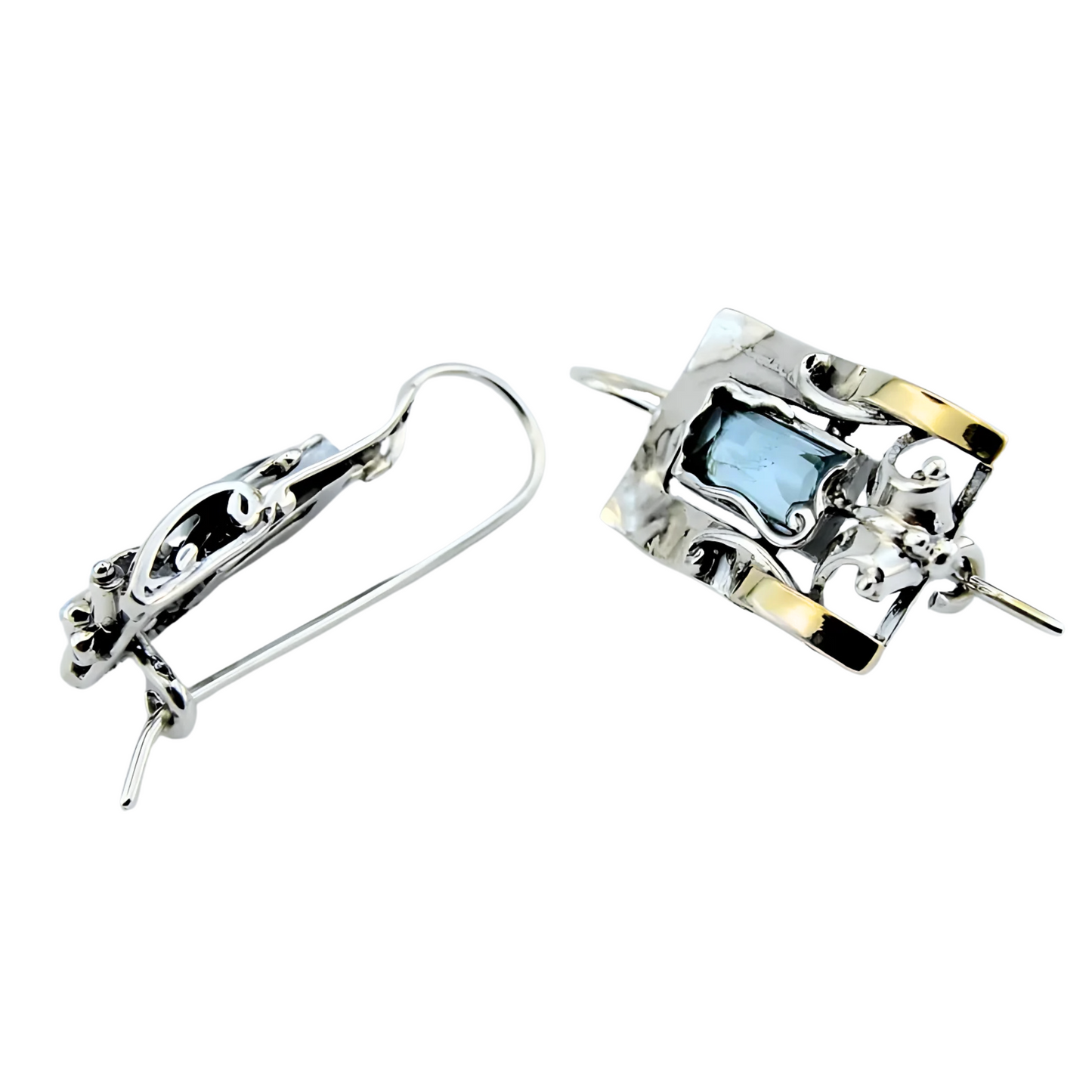 Handcrafted sterling silver earrings featuring a rectangular blue topaz gemstone with elegant yellow gold accents and intricate detailing, designed by Hadar Jewelry. These artisan earrings blend contemporary style with timeless sophistication, perfect for a unique statement look.