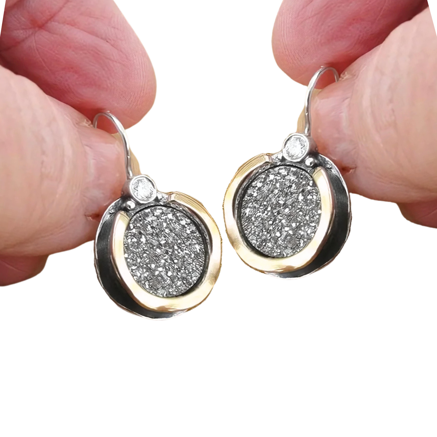 Elegant handmade sterling silver earrings featuring shimmering druzy gemstones set in a unique 9K yellow gold frame with clear zircon accents. These artisan-designed earrings by Hadar Jewelry combine the sparkle of druzy with the sophistication of gold and silver, creating a timeless piece perfect for both daily elegance and special occasions. The round shape and luxurious materials make these earrings an ideal statement accessory for those who appreciate fine, handcrafted jewelry.