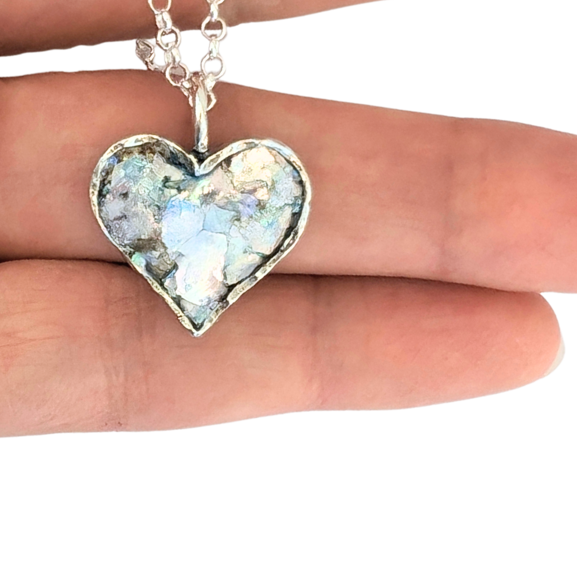 Authentic Roman Glass Heart Pendant in Sterling Silver, featuring a textured silver setting with a heart-shaped inlay of genuine Roman glass. Timeless, handcrafted jewelry, ready to ship for Christmas