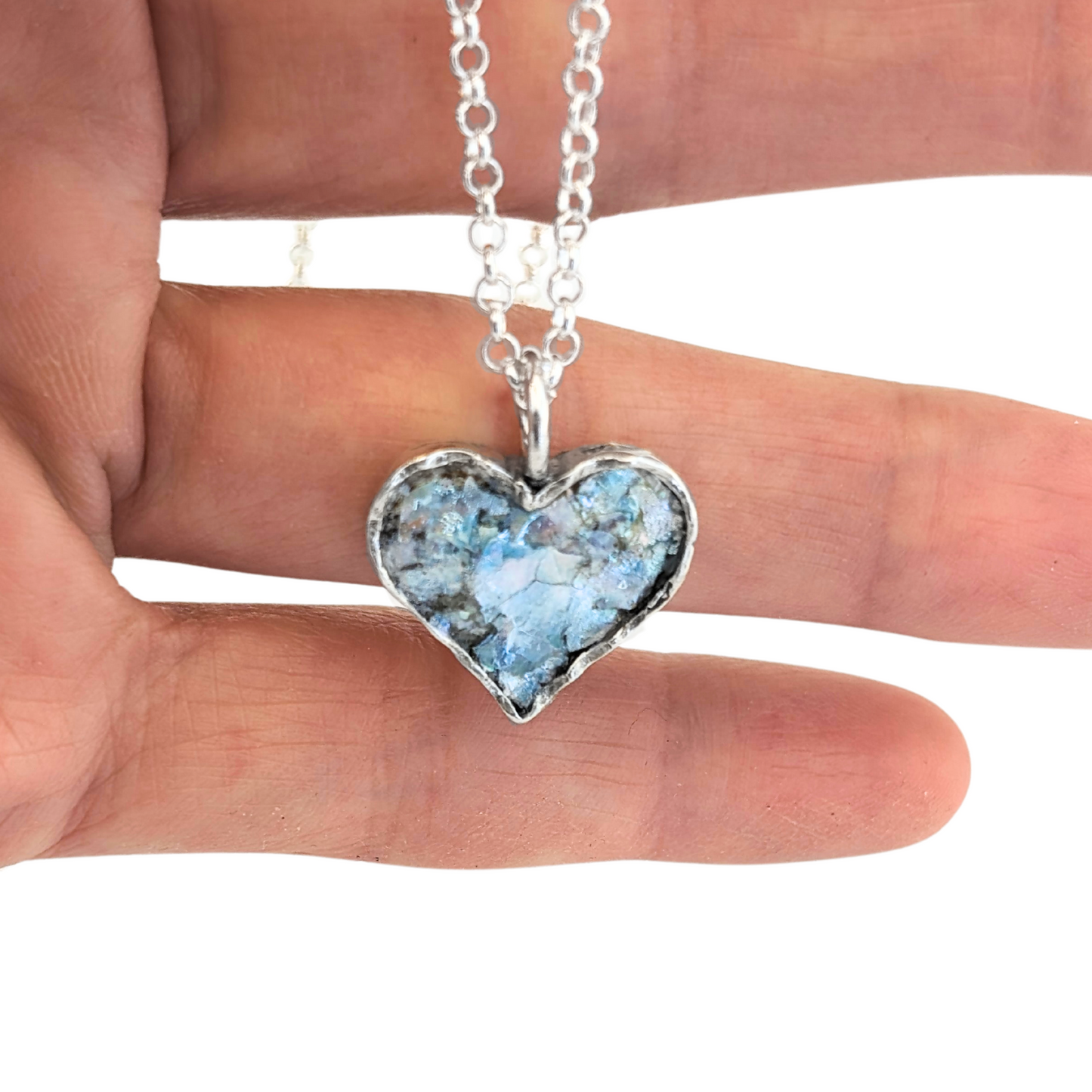 Authentic Roman Glass Heart Pendant in Sterling Silver, featuring a textured silver setting with a heart-shaped inlay of genuine Roman glass. Timeless, handcrafted jewelry, ready to ship for Christmas