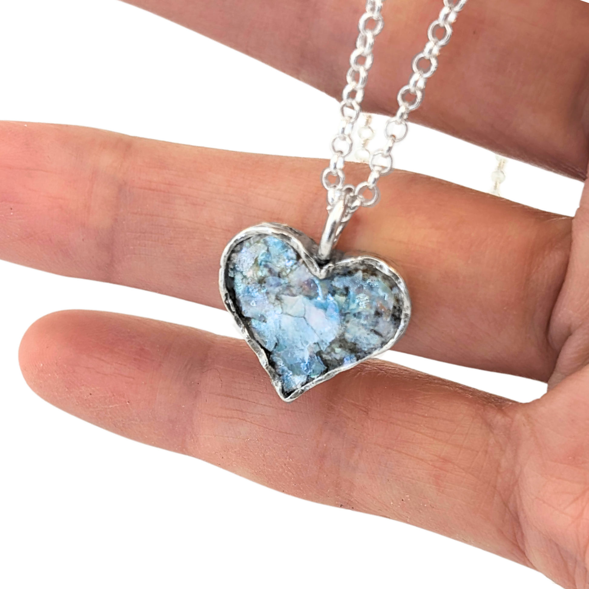 Authentic Roman Glass Heart Pendant in Sterling Silver, featuring a textured silver setting with a heart-shaped inlay of genuine Roman glass. Timeless, handcrafted jewelry, ready to ship for Christmas