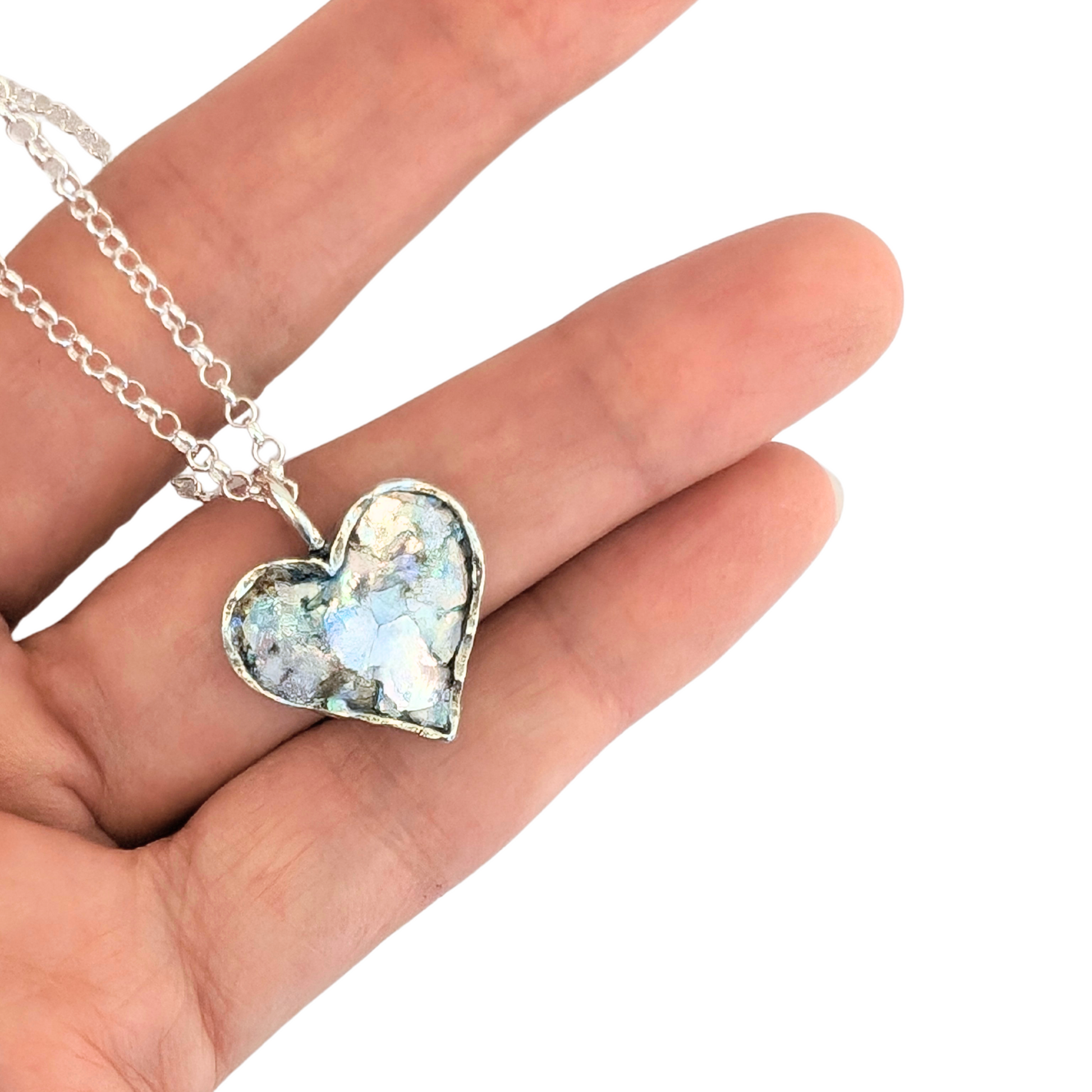 Authentic Roman Glass Heart Pendant in Sterling Silver, featuring a textured silver setting with a heart-shaped inlay of genuine Roman glass. Timeless, handcrafted jewelry, ready to ship for Christmas