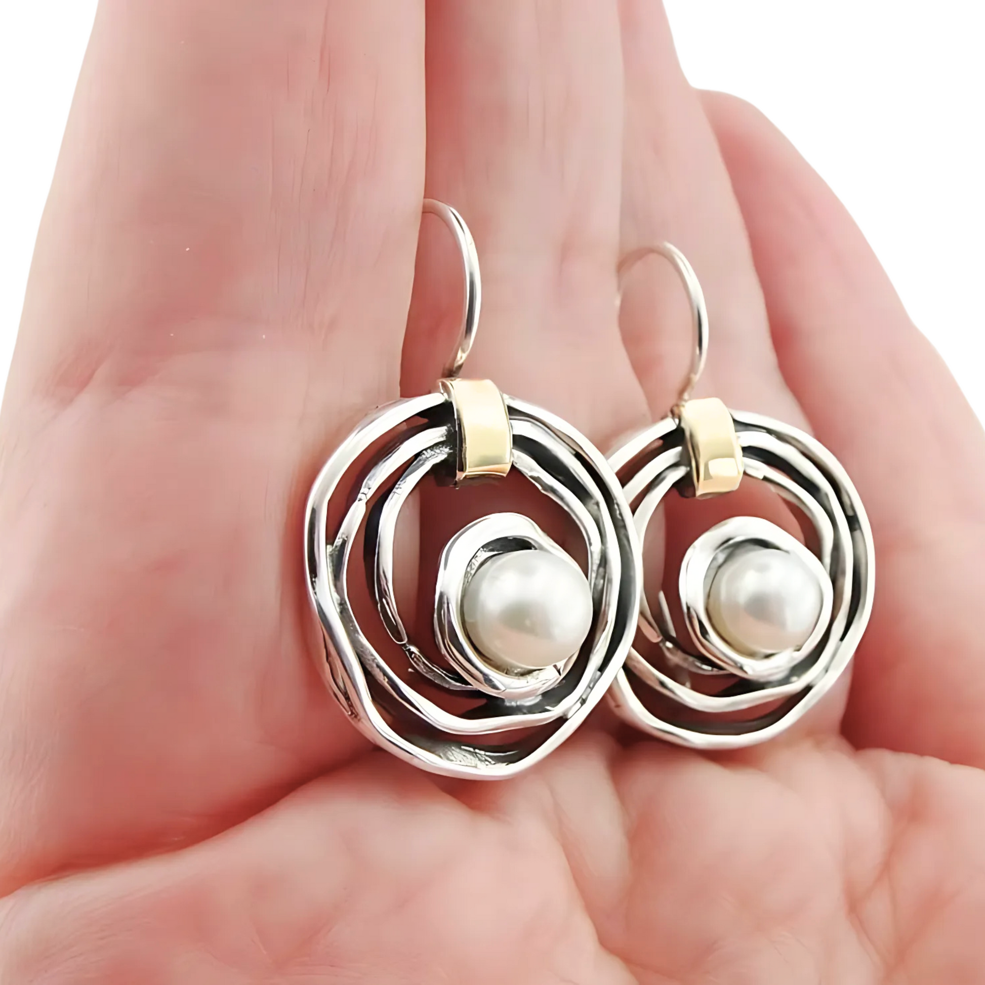 Elegant, handcrafted sterling silver earrings with a sophisticated open spiral design, featuring lustrous freshwater pearls as centerpieces and accented with delicate touches of yellow gold. These unique earrings, designed by Hadar Jewelry, blend modern aesthetics with timeless luxury, perfect for adding a refined, statement look to any ensemble.