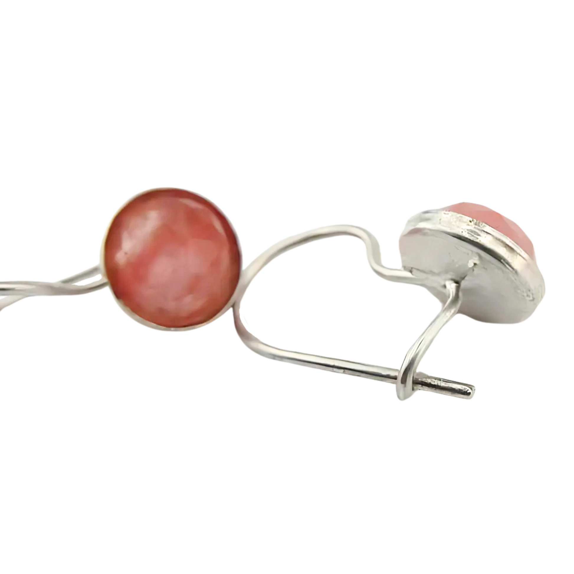 Sterling silver earrings featuring round 8mm rose quartz gemstones with a soft pink hue, set in a minimal yet elegant silver frame with secure hooks. The design highlights the natural beauty of the rose quartz stones, adding a refined touch to any outfit