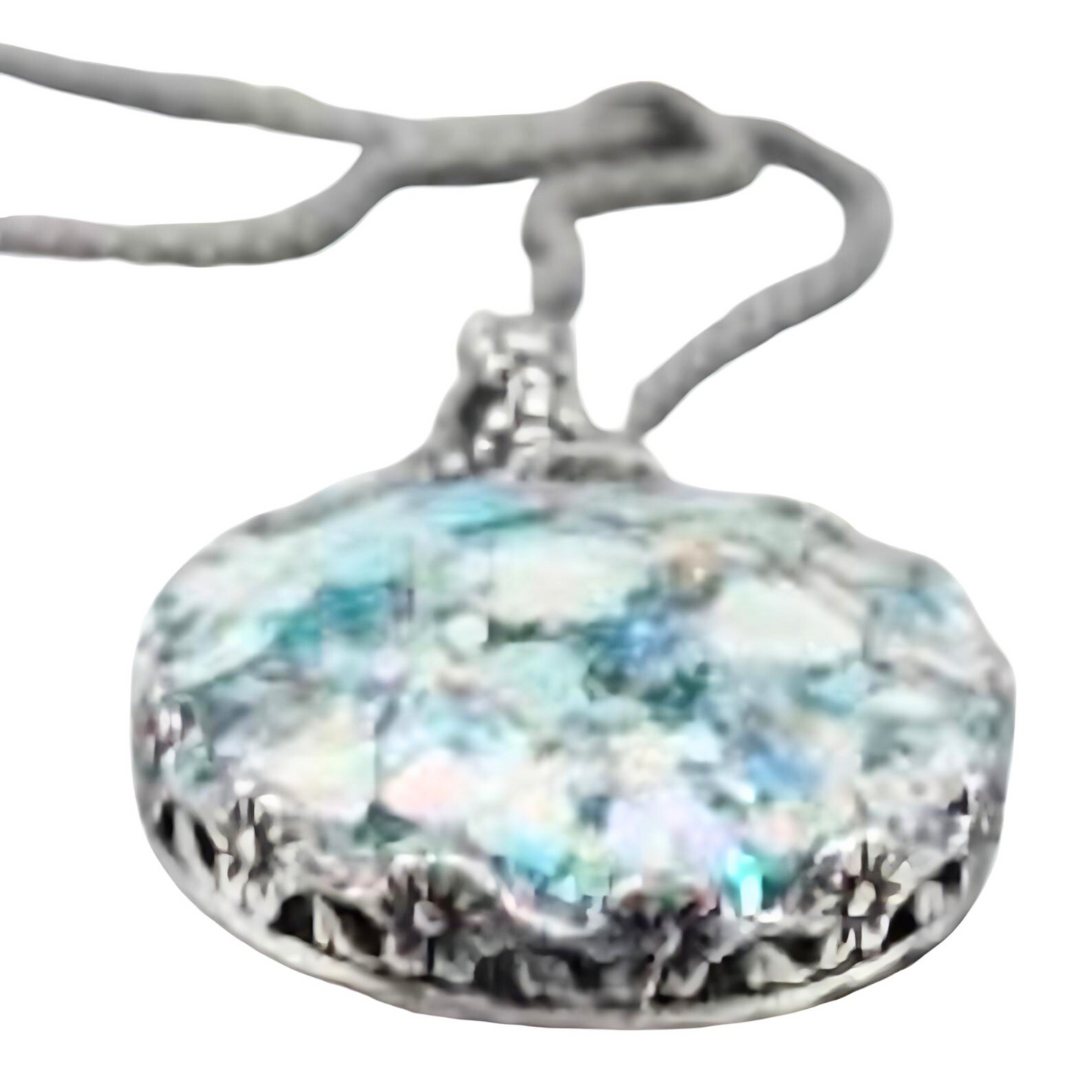 Handcrafted sterling silver pendant featuring a round Roman glass centerpiece in shades of light blue and silver. The unique, textured chain complements the pendant, creating a distinctive, artisanal look. Shown held in hand to display its intricate details and delicate craftsmanship