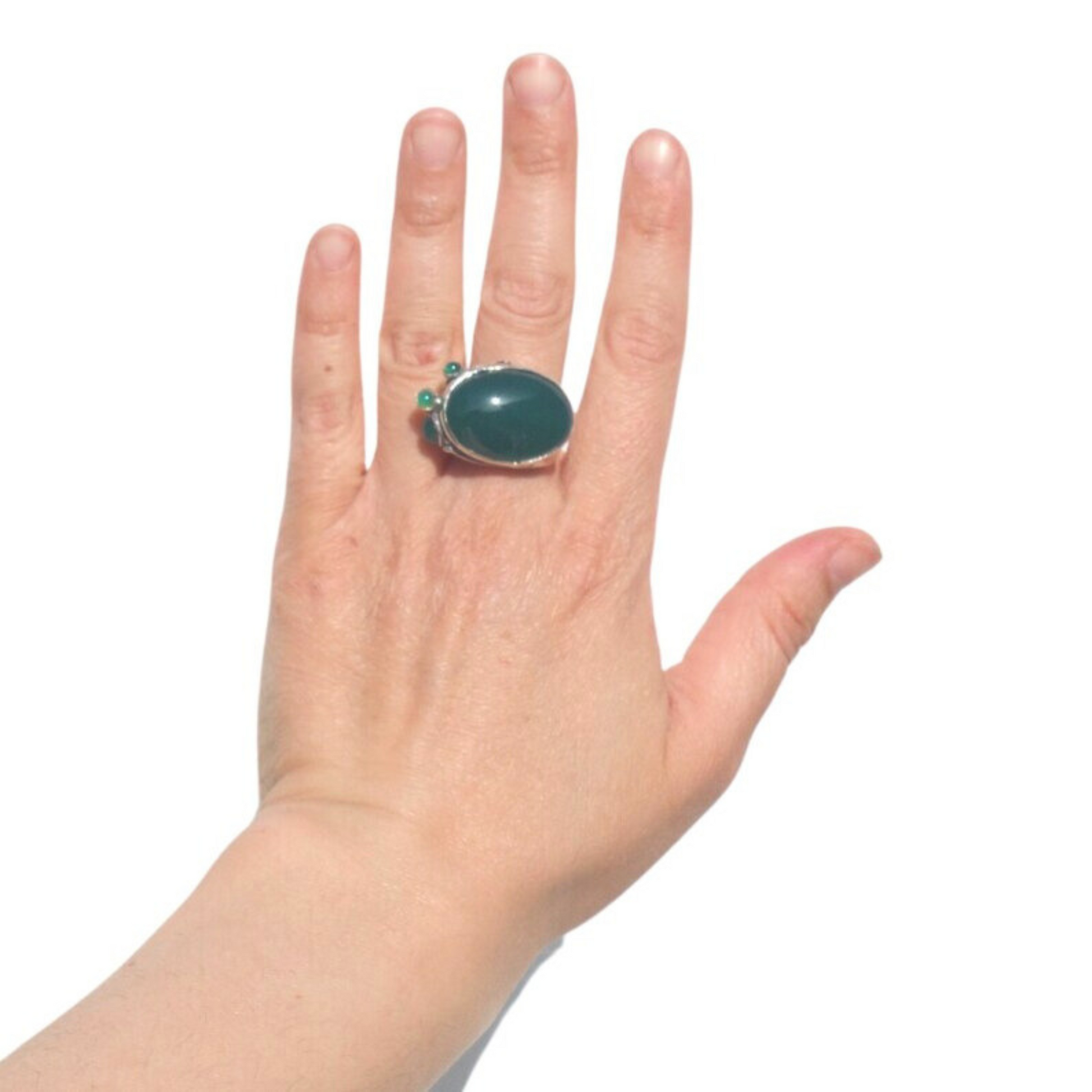 Sterling silver ring featuring a large natural green agate gemstone, set in a bold design. This unisex statement ring combines elegance and a touch of color, perfect for those who love unique, handcrafted jewelry.