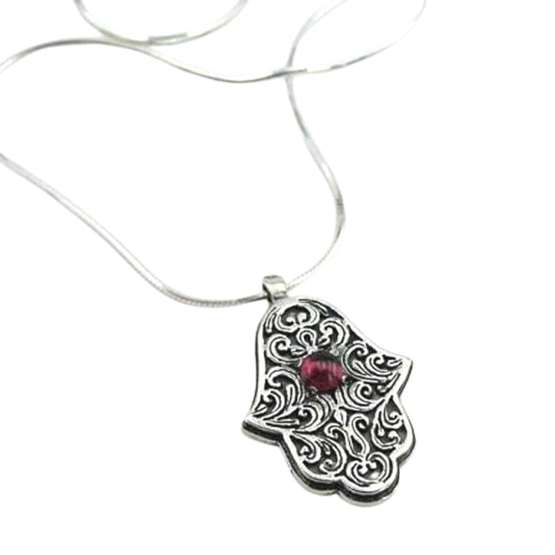 Sterling silver Hamsa pendant with intricate design and a natural garnet at the center, symbolizing protection and good luck. A meaningful and spiritual piece of jewelry, perfect for a gift and adding positive energy.