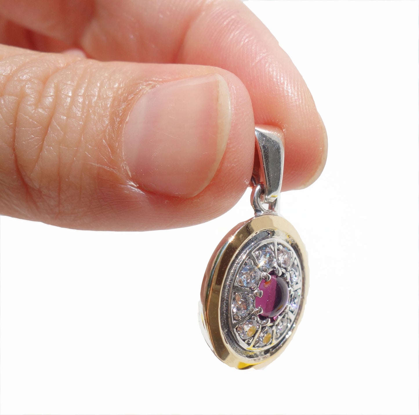 Gold decorated with white Zircon inlaid, sterling silver, and Garnet Gemstone. Arrive with Sterling silver