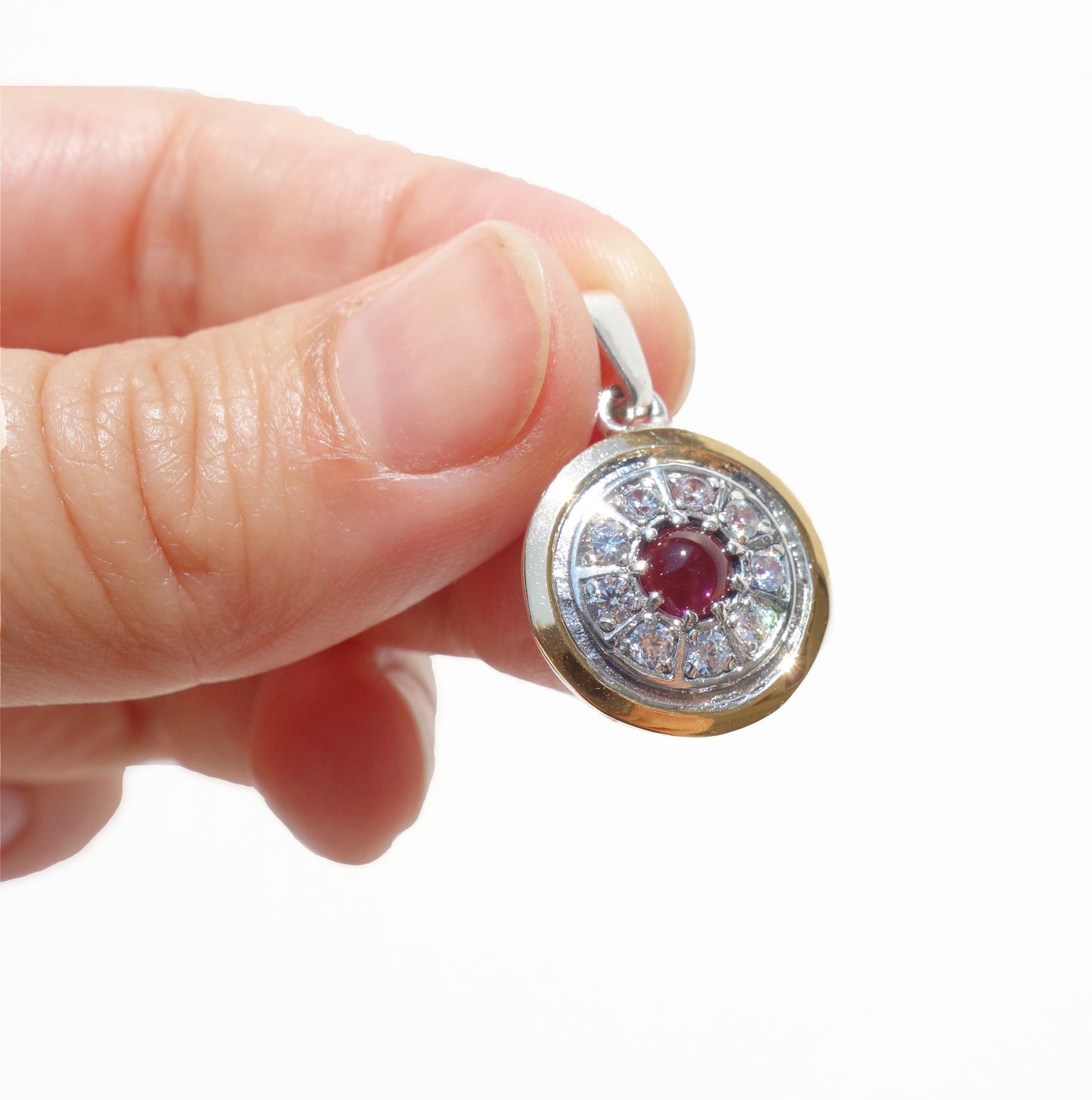 Gold decorated with white Zircon inlaid, sterling silver, and Garnet Gemstone. Arrive with Sterling silver