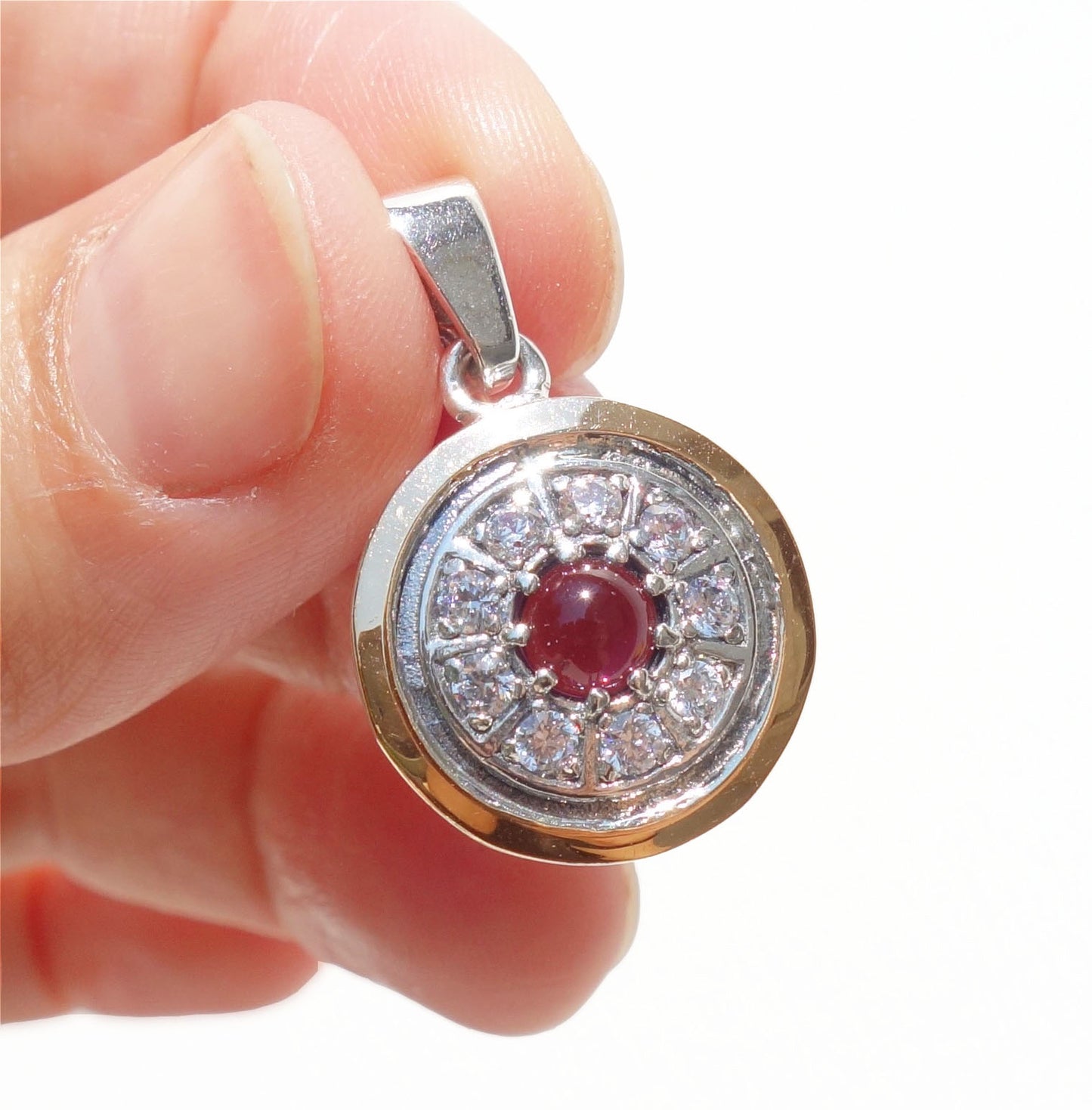 Gold decorated with white Zircon inlaid, sterling silver, and Garnet Gemstone. Arrive with Sterling silver