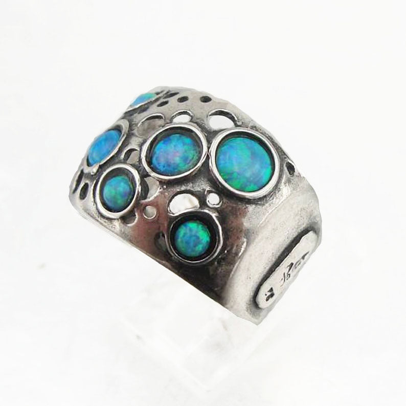 Sterling silver wide ring with blue opal dots.