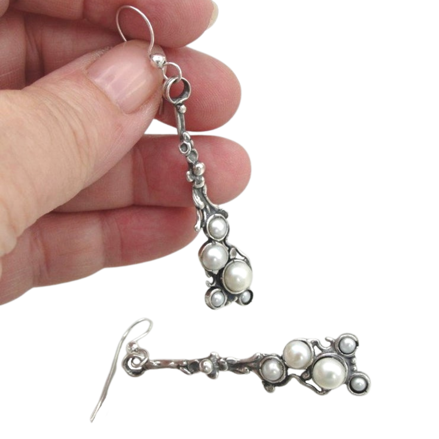 Long sterling silver earrings decorated with white natural pearls.