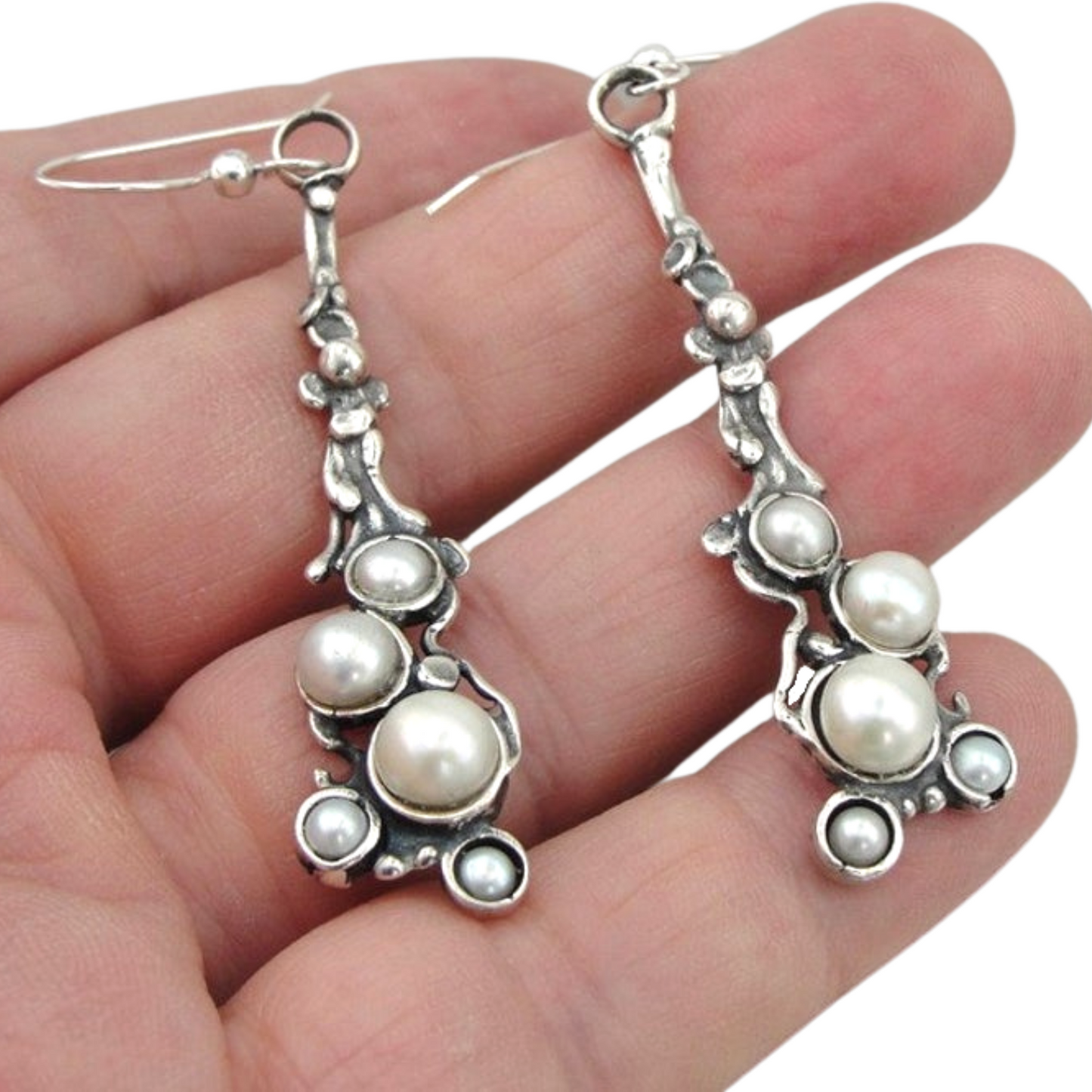 Long sterling silver earrings decorated with white natural pearls.